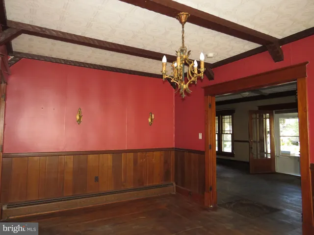 a view of a livingroom with wooden floor and a ceiling fan