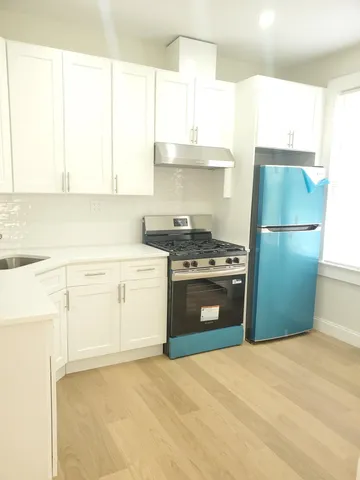 a kitchen with a sink a stove and a refrigerator