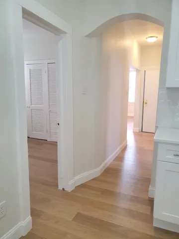 a view of hallway with wooden floor