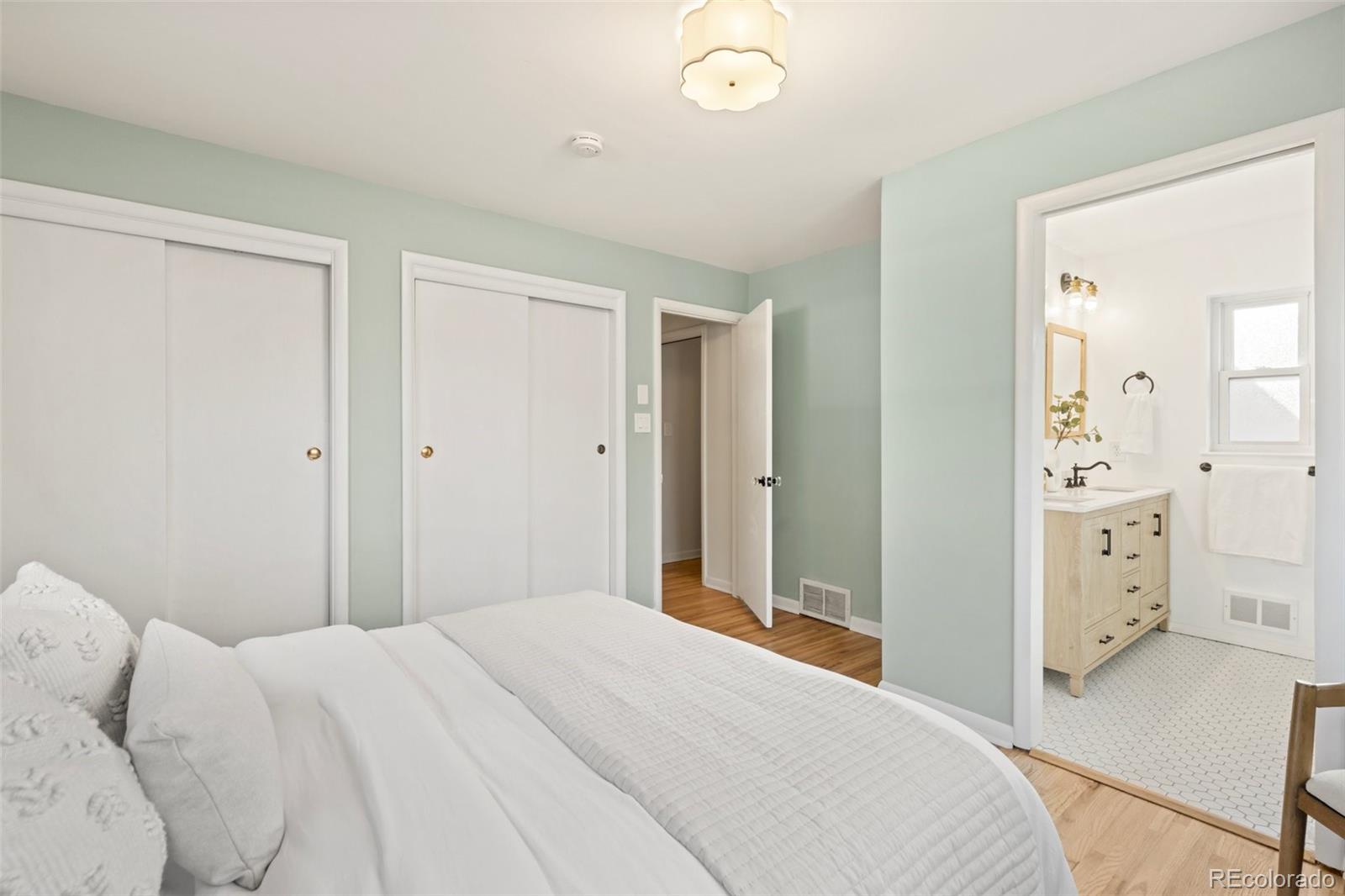 5520 East Bails Drive Denver, CO 80222 - Photo 13 of 38 a bedroom with a bed and cabinets