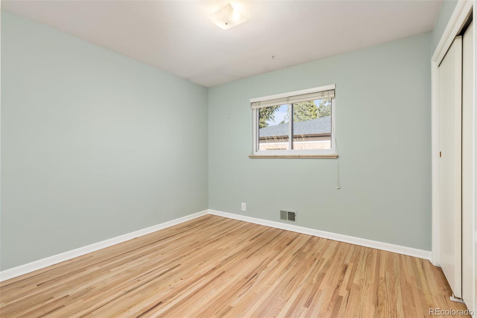 5520 East Bails Drive Denver, CO 80222 - Photo 15 of 38 a view of empty room with wooden floor