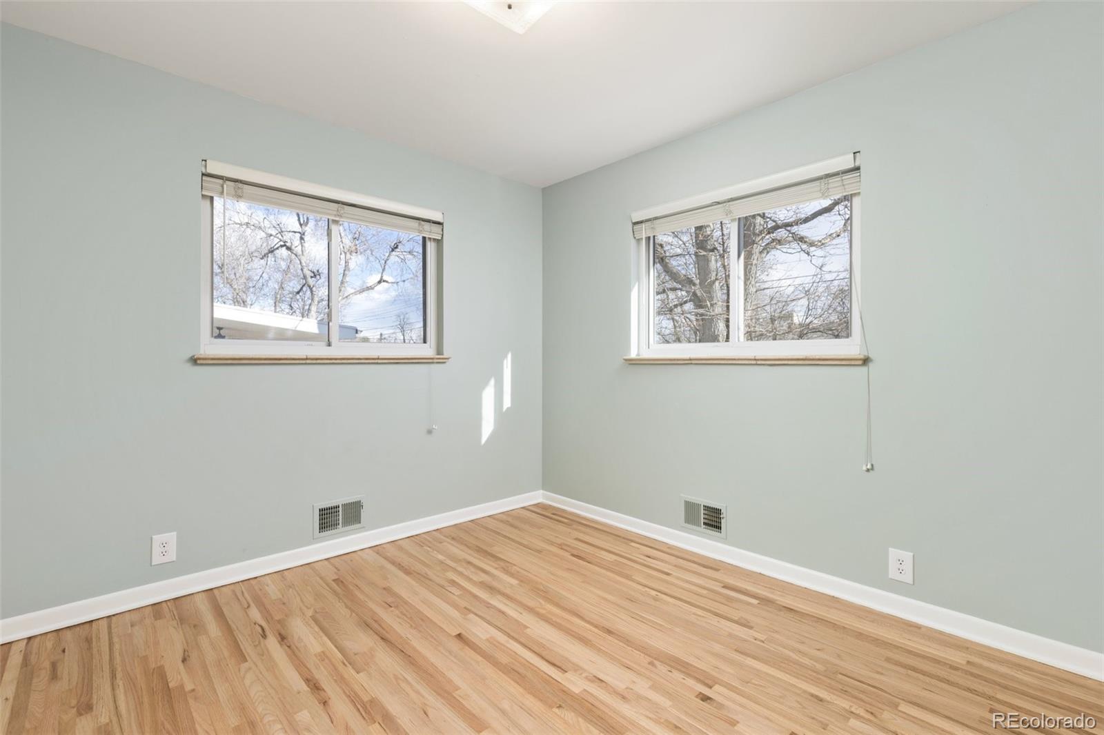 5520 East Bails Drive Denver, CO 80222 - Photo 16 of 38 a view of room with window and wooden floor