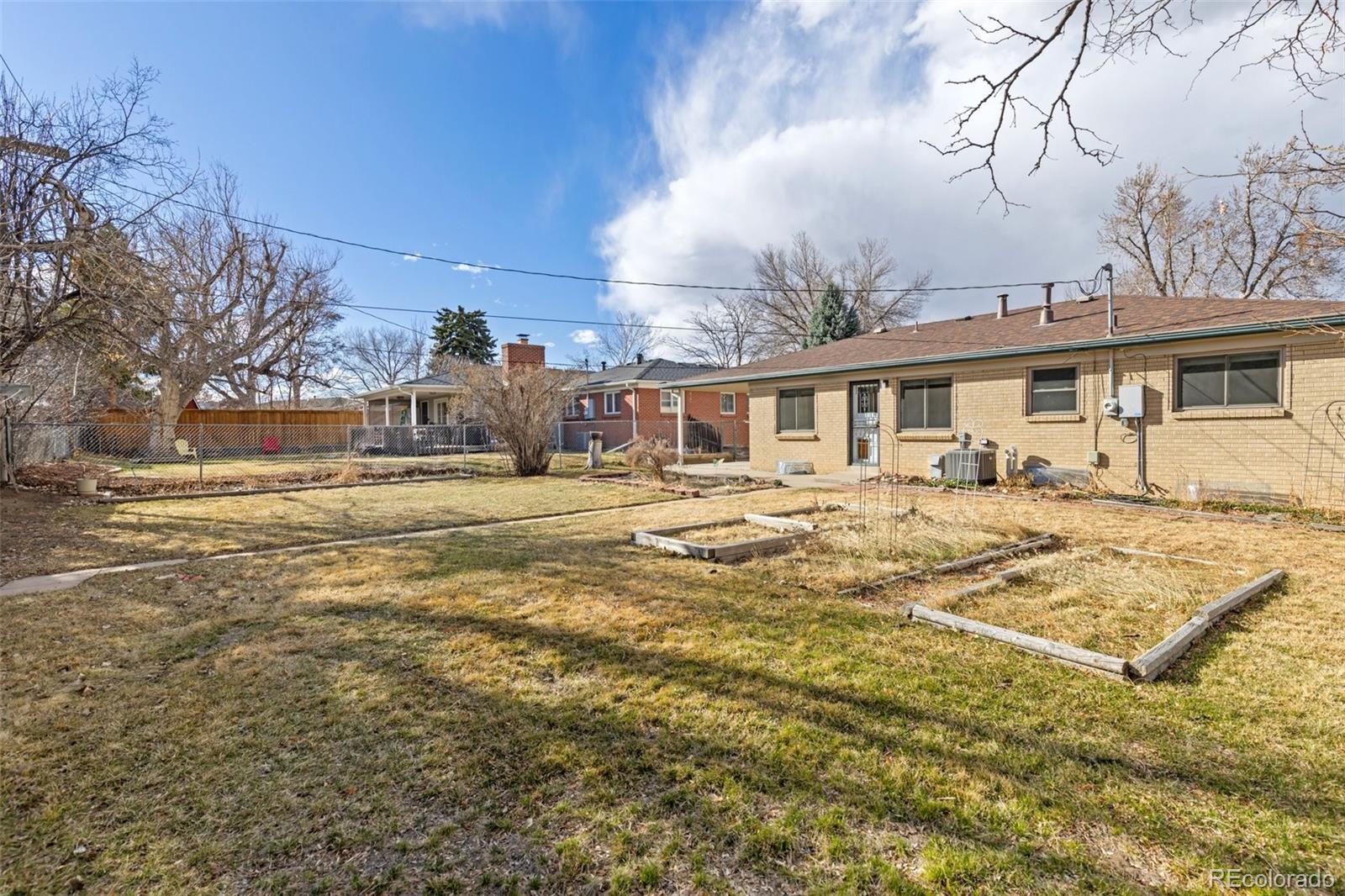 5520 East Bails Drive Denver, CO 80222 - Photo 24 of 38 a view of a house with a yard