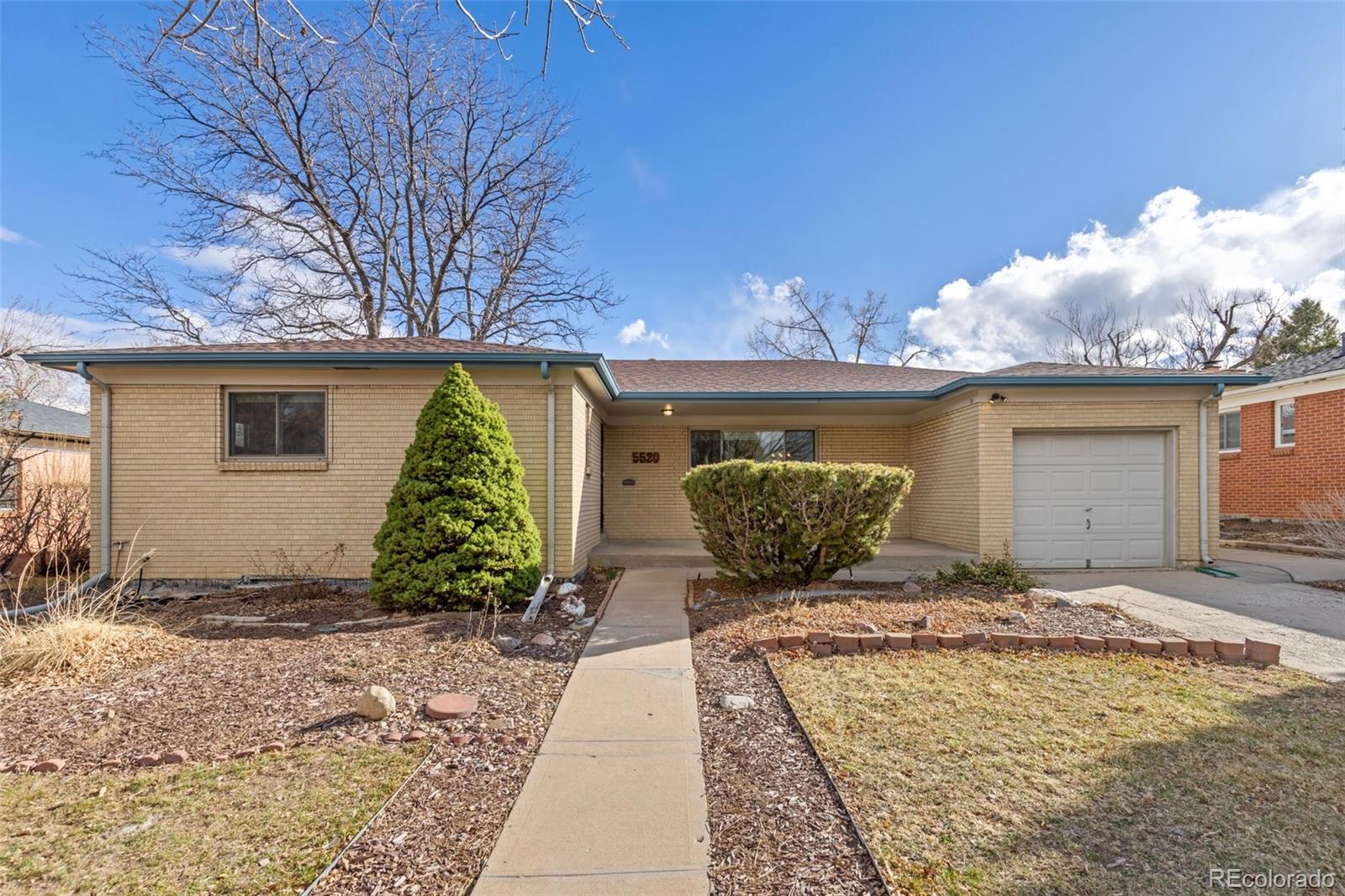 5520 East Bails Drive Denver, CO 80222 - Photo 30 of 38 a front view of a house with garden