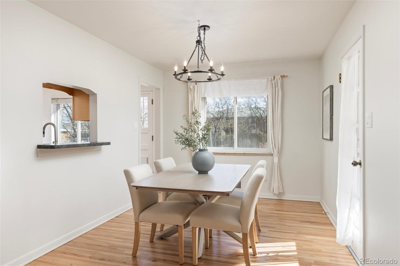 5520 East Bails Drive Denver, CO 80222 - Photo 7 of 38 a view of a dining room with furniture window and wooden floor