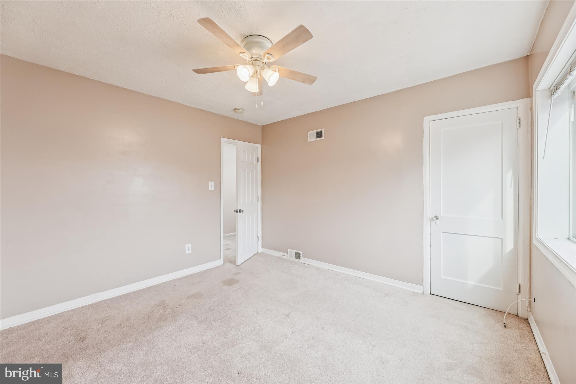 4007 1st Street Southwest Washington, DC 20032 - Photo 12 of 48 an empty room with a chandelier fan