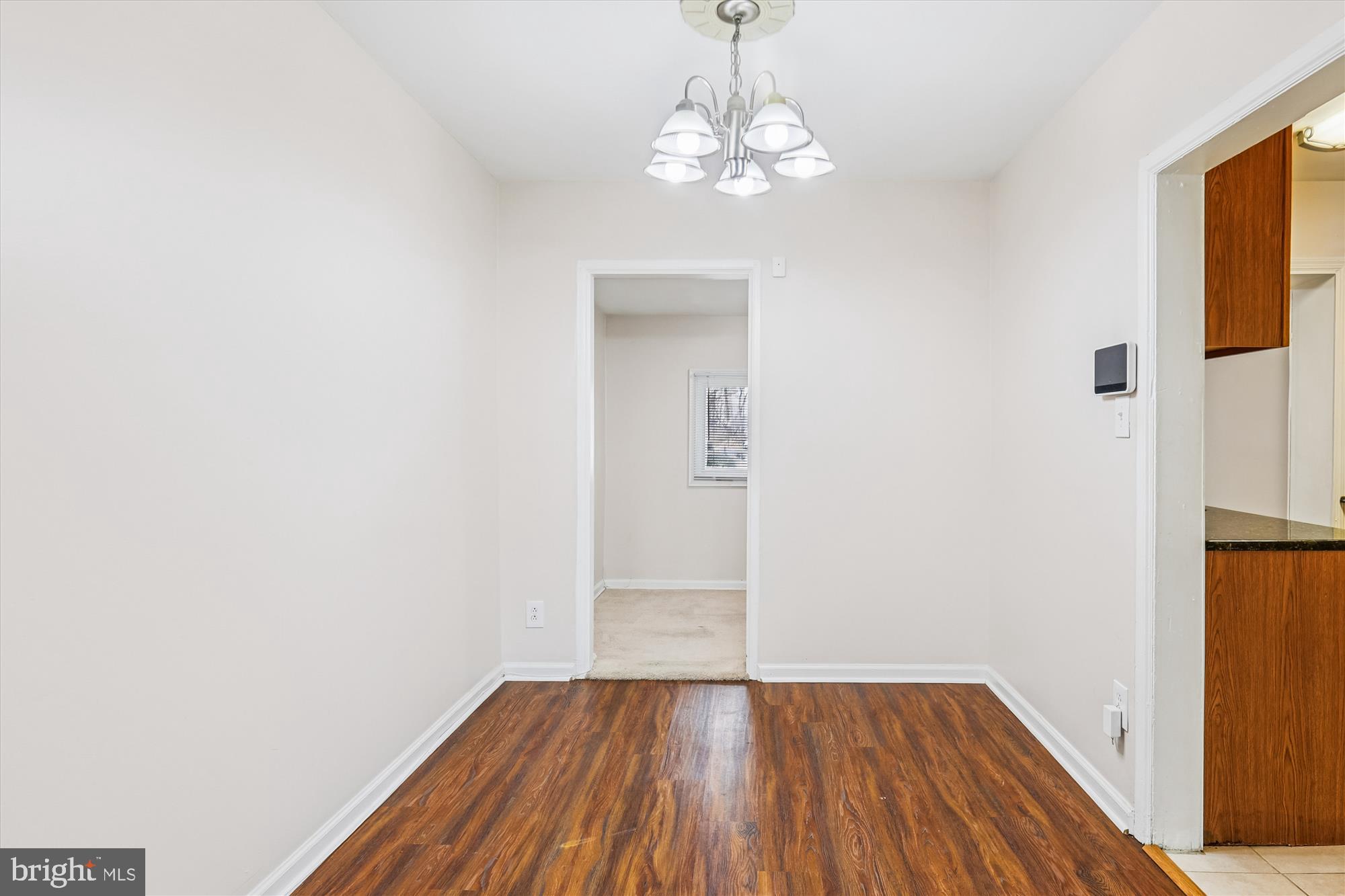 4007 1st Street Southwest Washington, DC 20032 - Photo 9 of 49 a view of a hallway with wooden floor and a chandelier