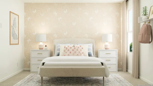 a bedroom with a large bed and a chandelier