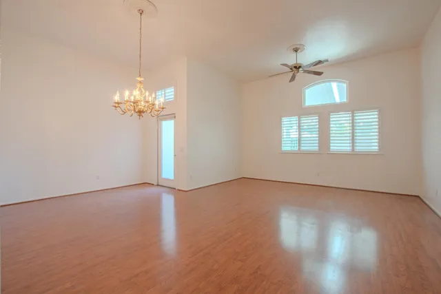 a view of a livingroom with a chandelier fan