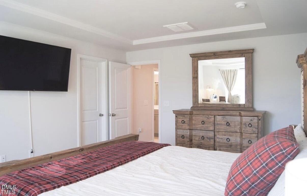 5006 Tura Street Raleigh, NC 27610 - Photo 16 of 32 a bedroom with a bed and a flat screen tv
