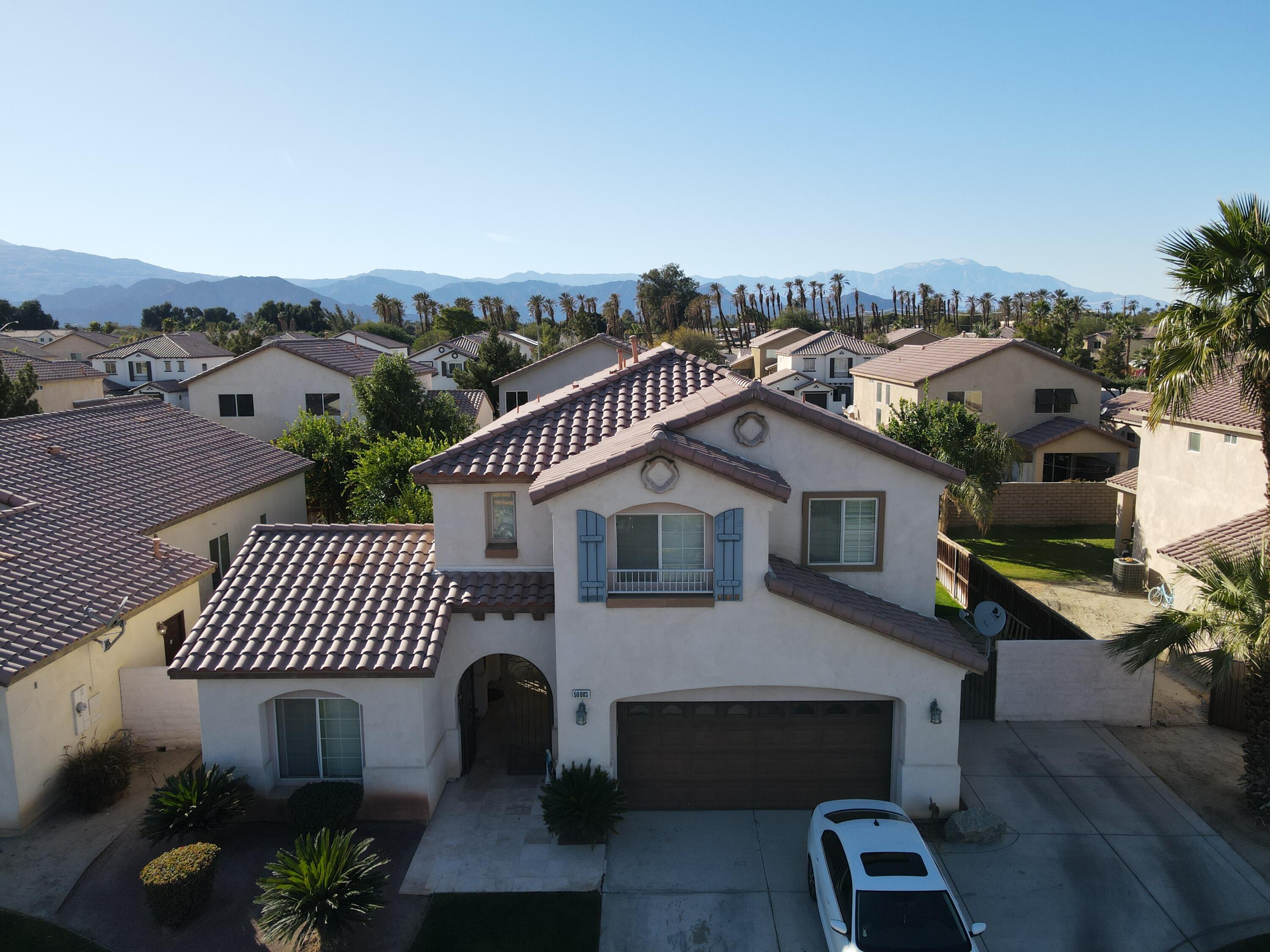 50083 San Solano Road Coachella, CA 92236 - Photo 3 of 6 a front view of a house with a garden