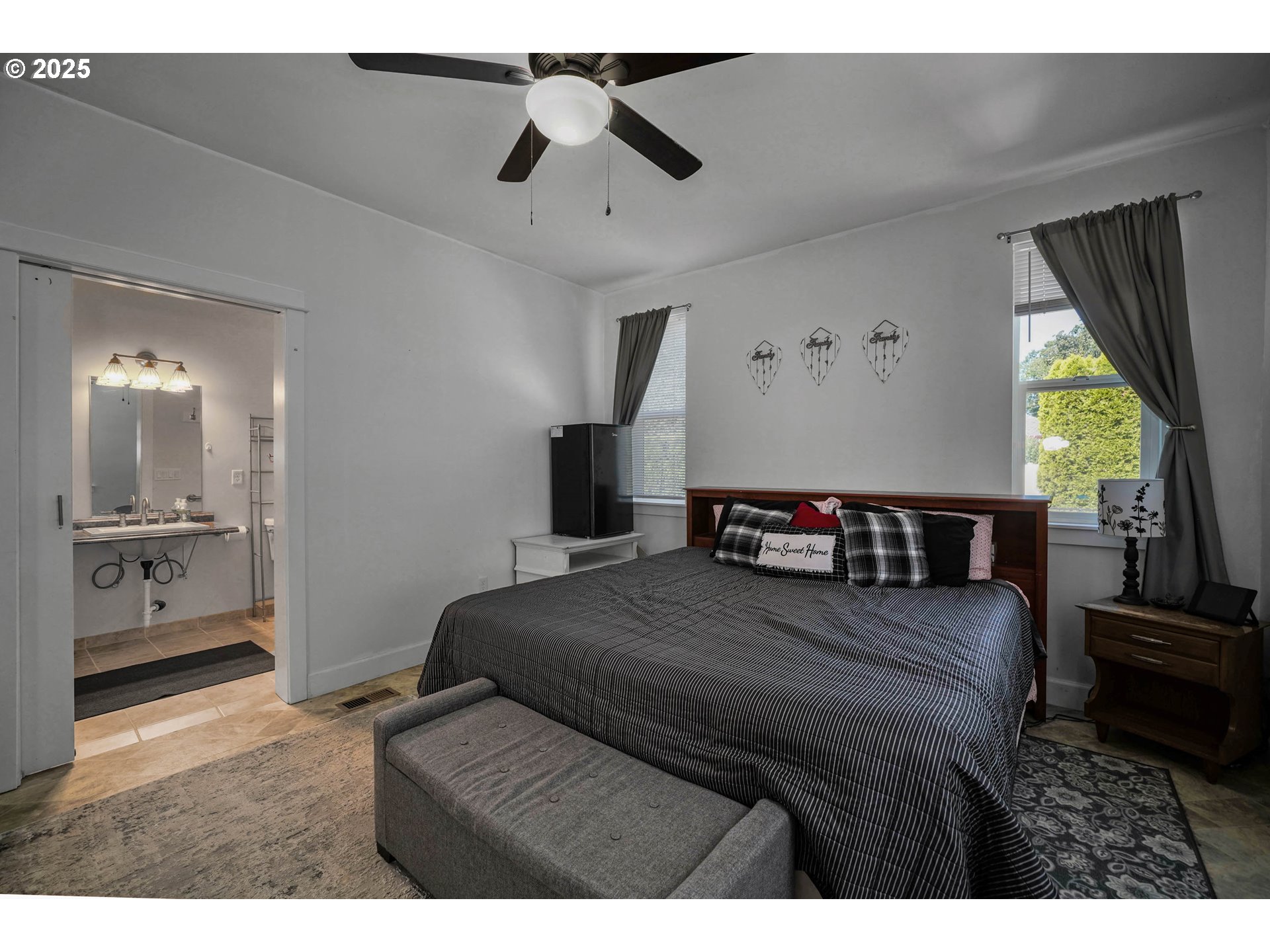 466 Northwest Denton Avenue Dallas, OR 97338 - Photo 17 of 43 a bedroom with a large bed and a chandelier