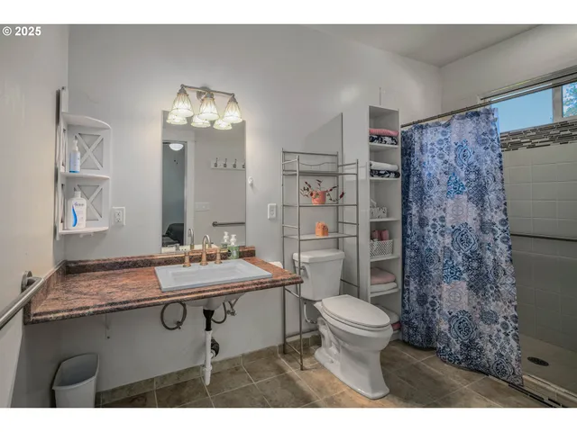 a bathroom with a sink toilet and shower