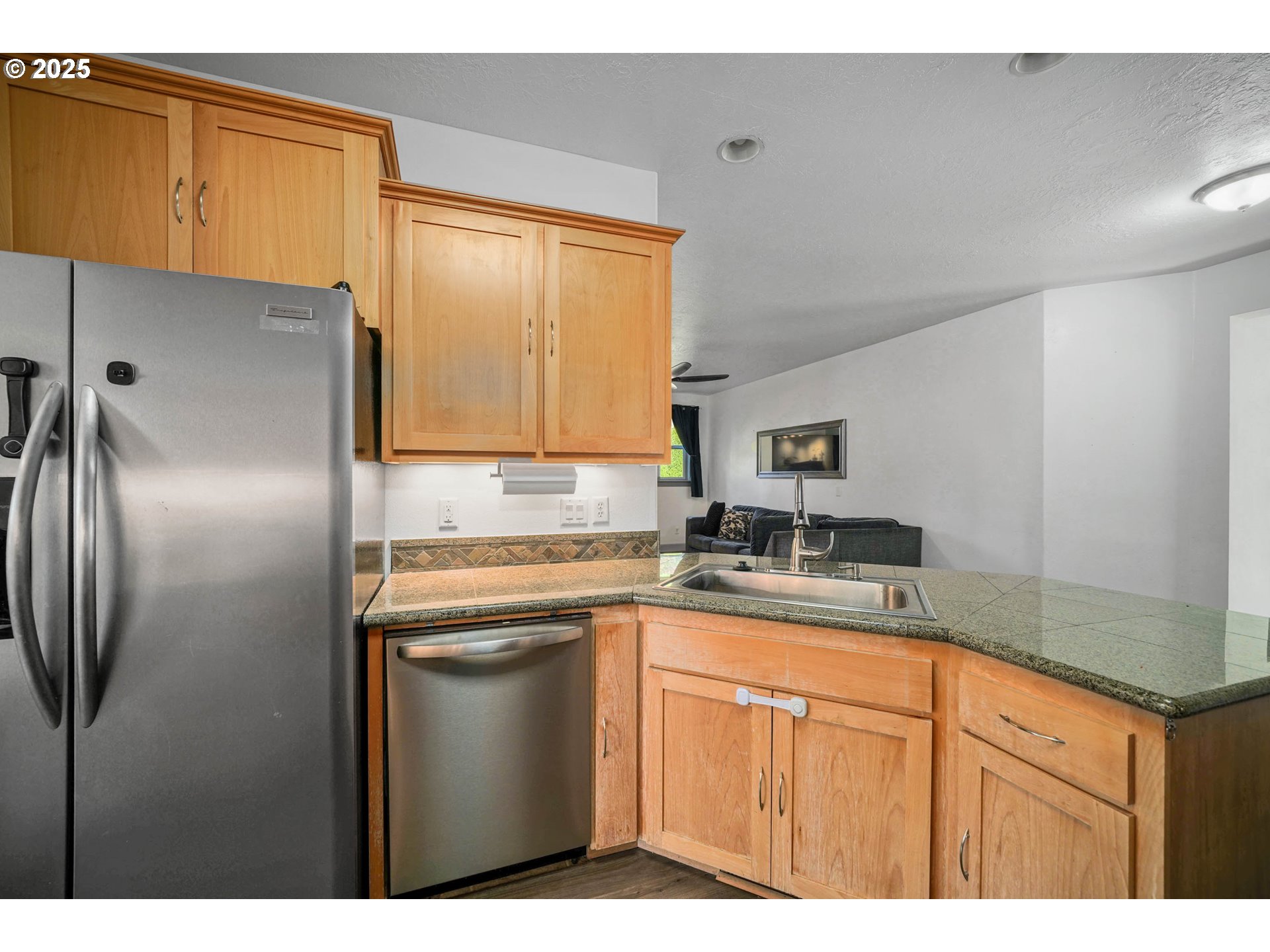 466 Northwest Denton Avenue Dallas, OR 97338 - Photo 9 of 43 a kitchen with stainless steel appliances granite countertop a refrigerator a sink a stove and island