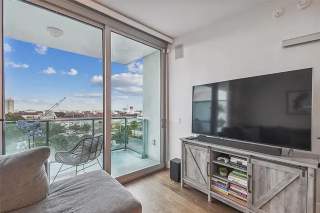 a area with furniture and a floor to ceiling window