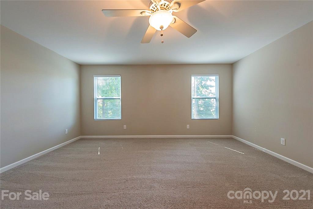 9019 Klein Road Fort Mill, SC 29715 - Photo 13 of 19 an empty room with windows and chandelier fan