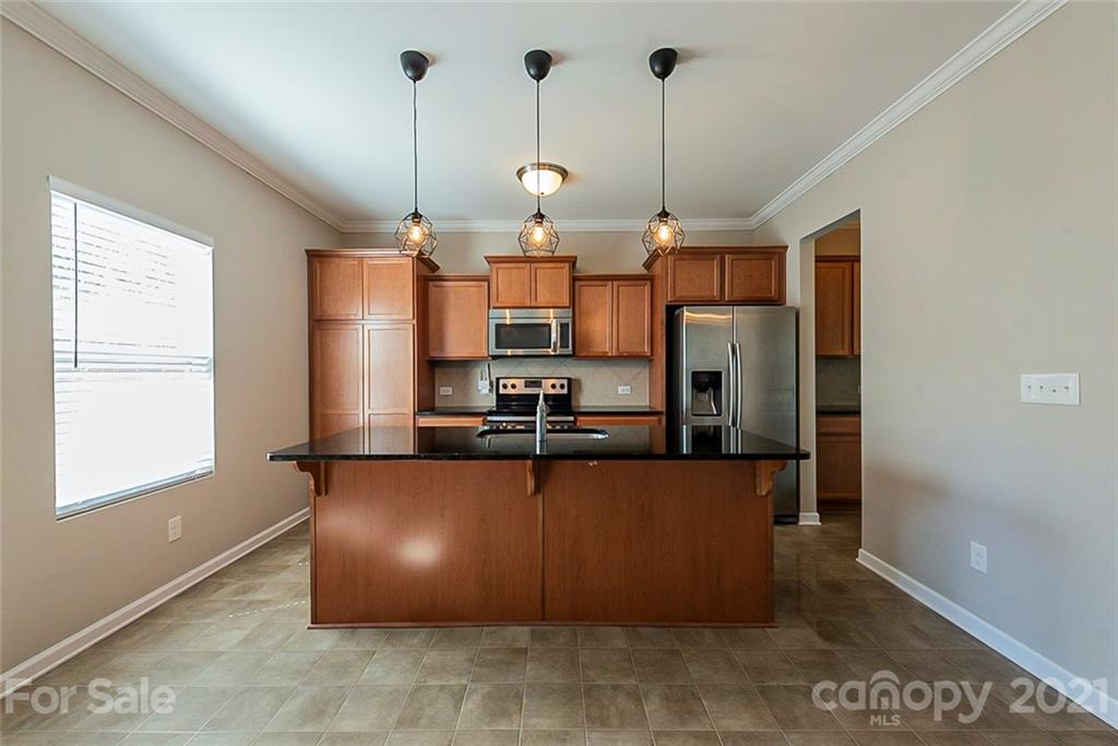 9019 Klein Road Fort Mill, SC 29715 - Photo 4 of 19 a kitchen with stainless steel appliances granite countertop a refrigerator a sink and a stove