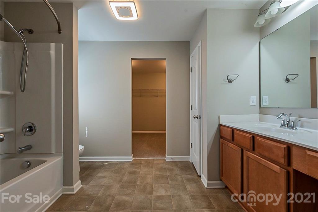 9019 Klein Road Fort Mill, SC 29715 - Photo 6 of 19 a bathroom with a tub sink and mirror