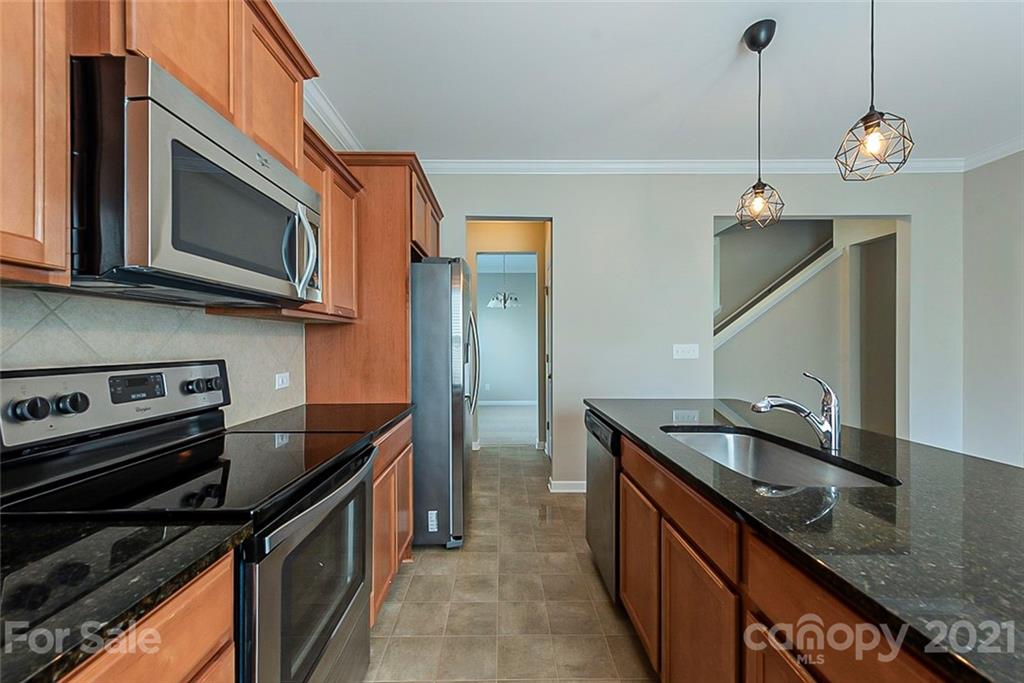9019 Klein Road Fort Mill, SC 29715 - Photo 8 of 19 a kitchen with stainless steel appliances granite countertop a sink a stove and a microwave