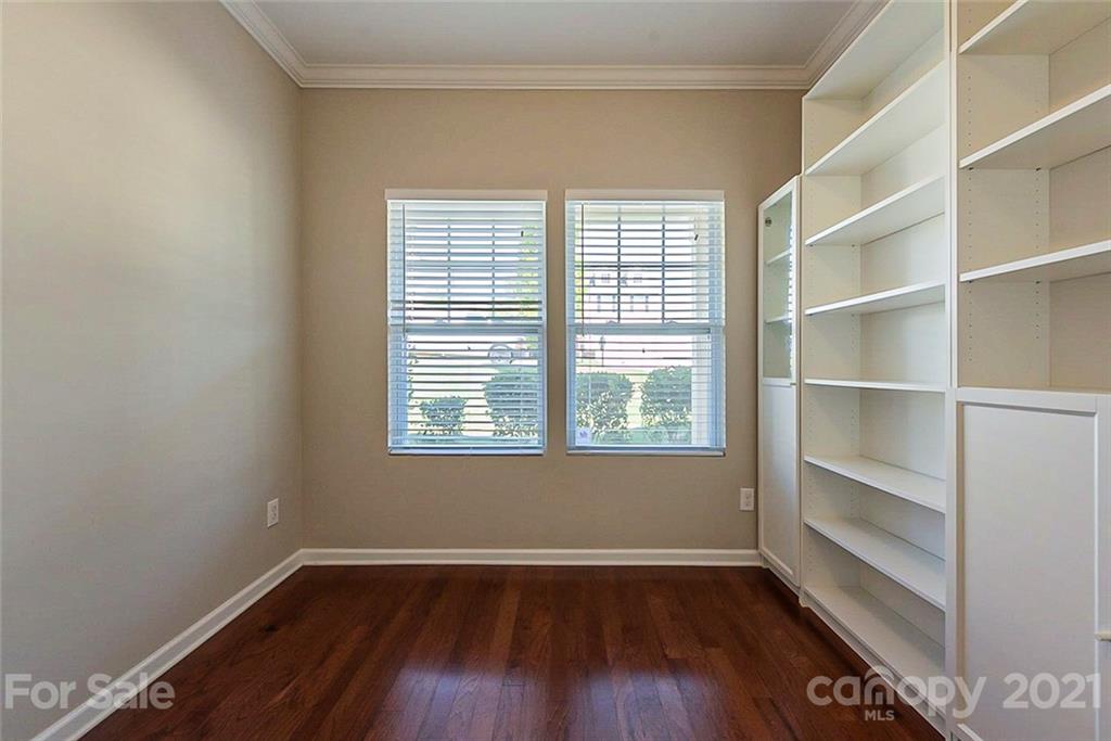 9019 Klein Road Fort Mill, SC 29715 - Photo 9 of 19 a view of an empty room with a window and wooden floor