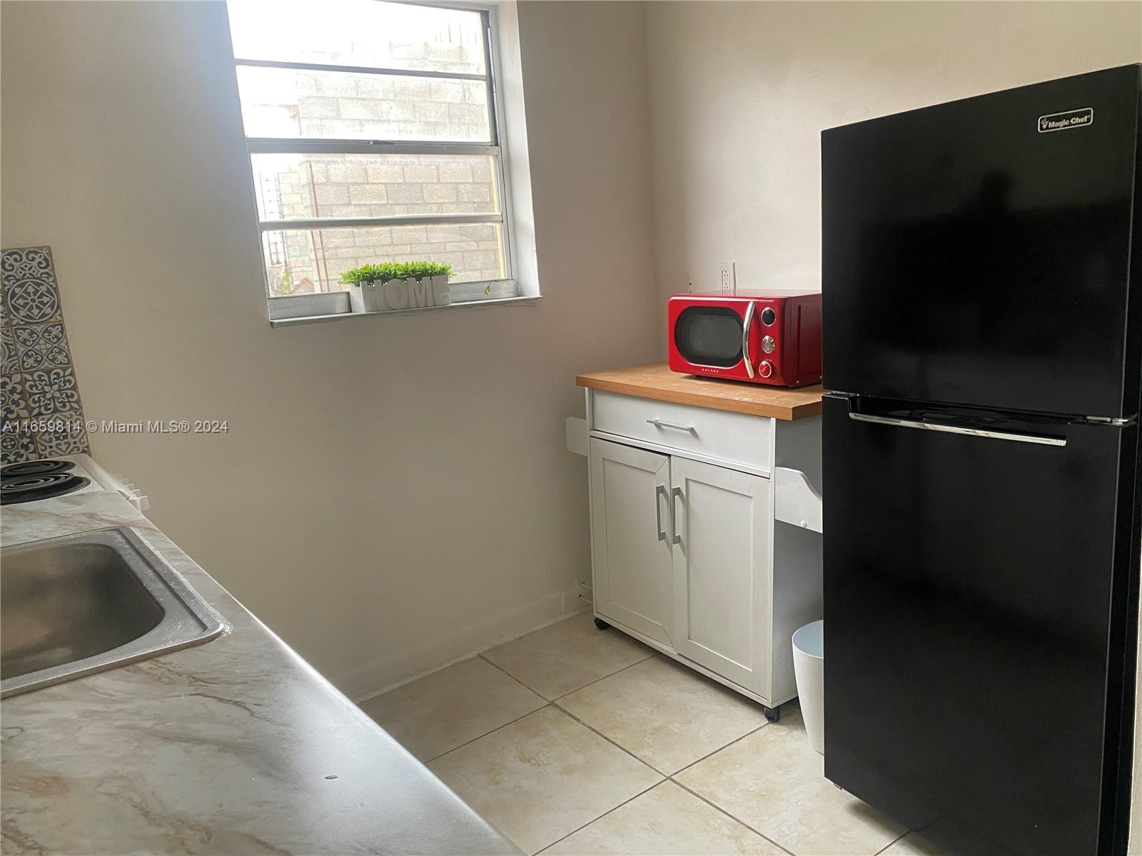 1043 Northwest 2nd Street, Unit 16 Miami, FL 33128 - Photo 12 of 17 a utility room with window dryer and washer