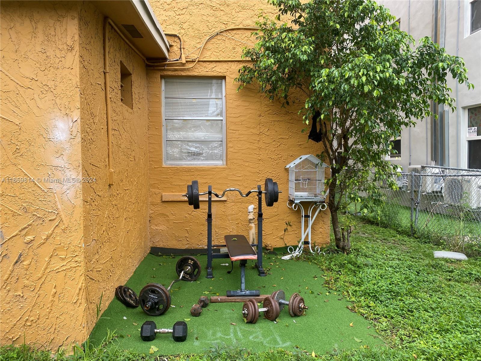 1043 Northwest 2nd Street, Unit 16 Miami, FL 33128 - Photo 4 of 17 a house view with a garden space