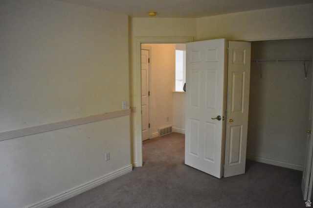 3327 East Windhover Road Eagle Mountain, UT 84005 - Photo 19 of 38 Carpeted room with neutral-toned walls, white baseboards, and a chair rail