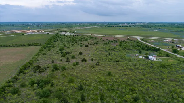 a view of a green field with an ocean