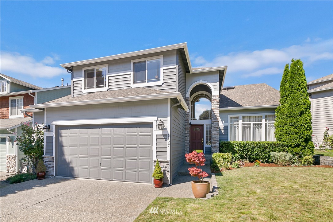 1127 185th Place Southeast Bothell, WA 98012 - Photo 1 of 25 a front view of a house with a yard