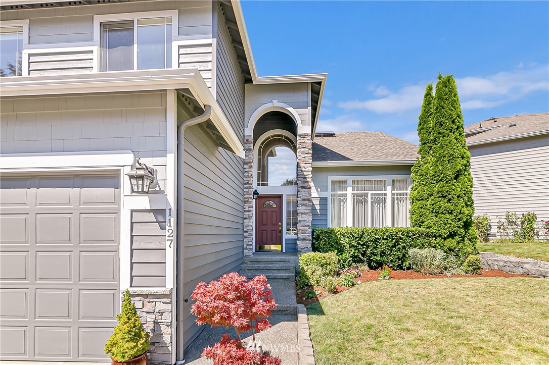 1127 185th Place Southeast Bothell, WA 98012 - Photo 2 of 25 a front view of a house with a yard