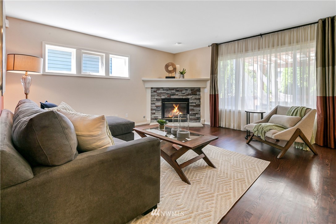 1127 185th Place Southeast Bothell, WA 98012 - Photo 11 of 25 a living room with furniture and a fireplace