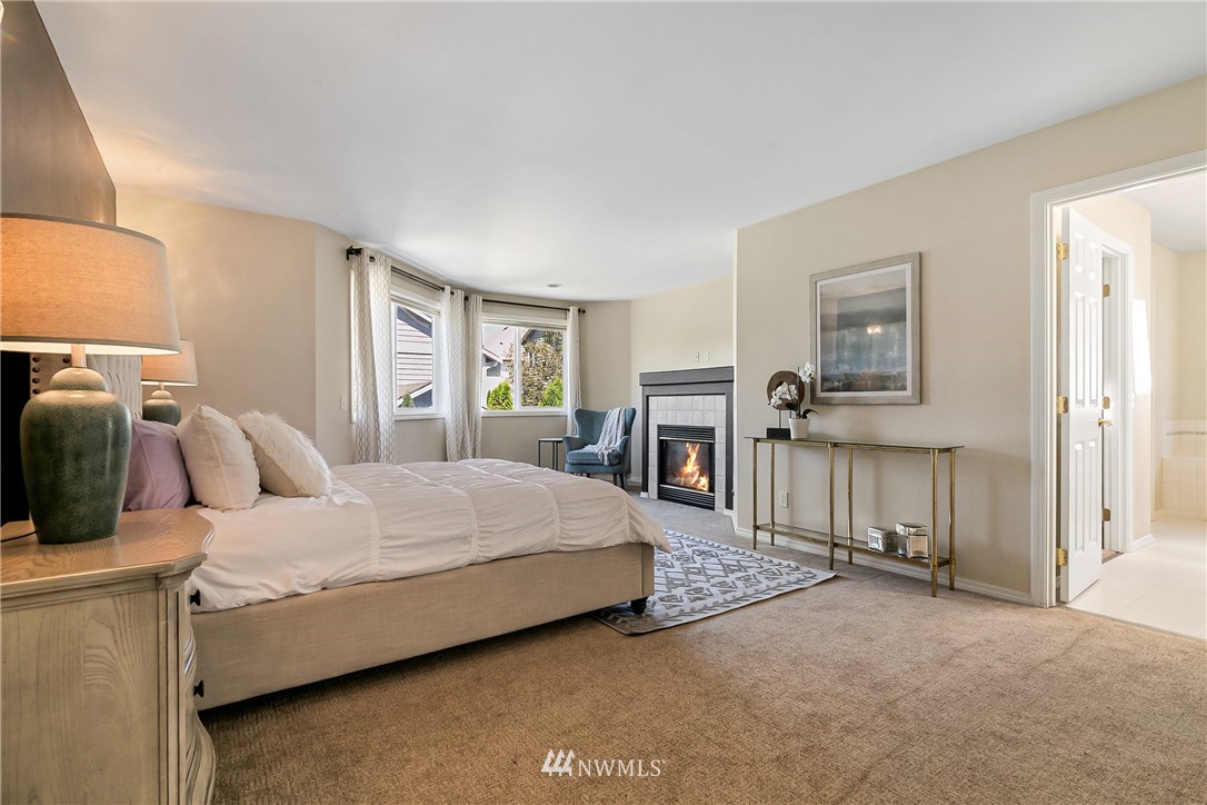 1127 185th Place Southeast Bothell, WA 98012 - Photo 17 of 25 a bedroom with a bed and a chandelier