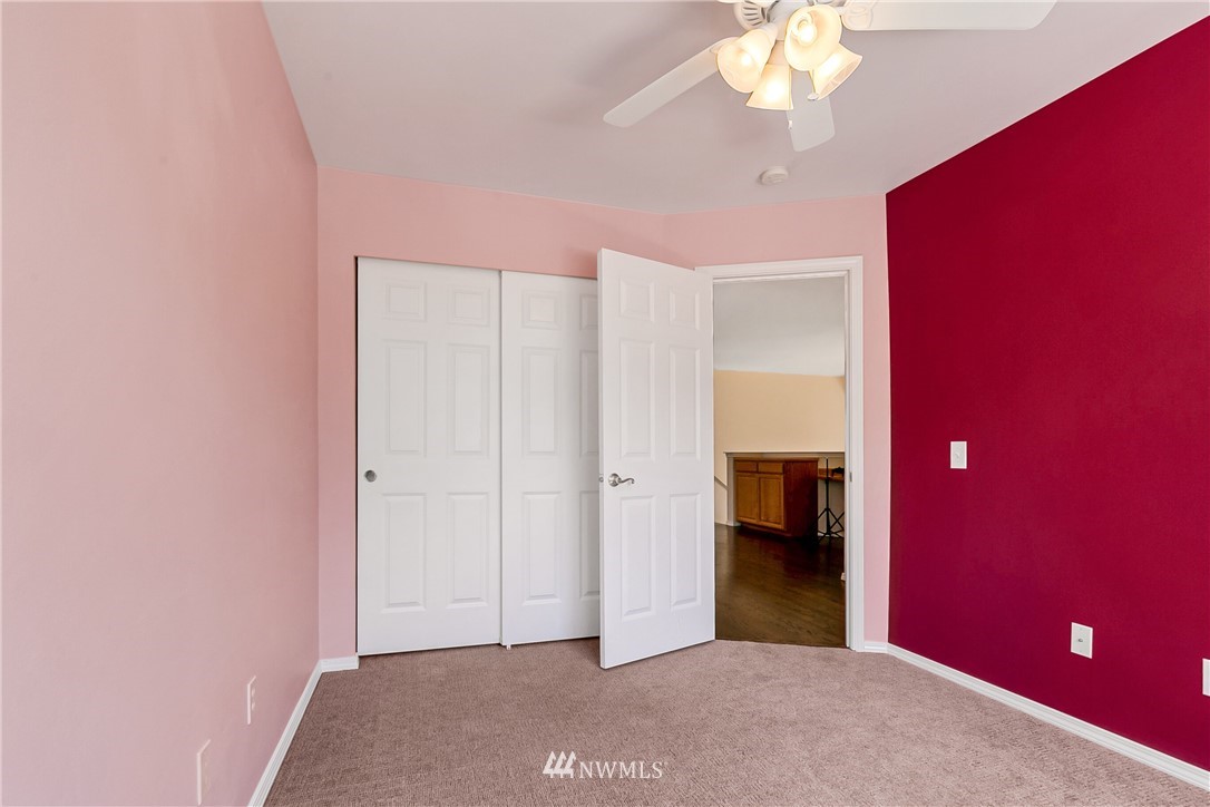 1127 185th Place Southeast Bothell, WA 98012 - Photo 20 of 25 a view of a livingroom with a chandelier fan and windows