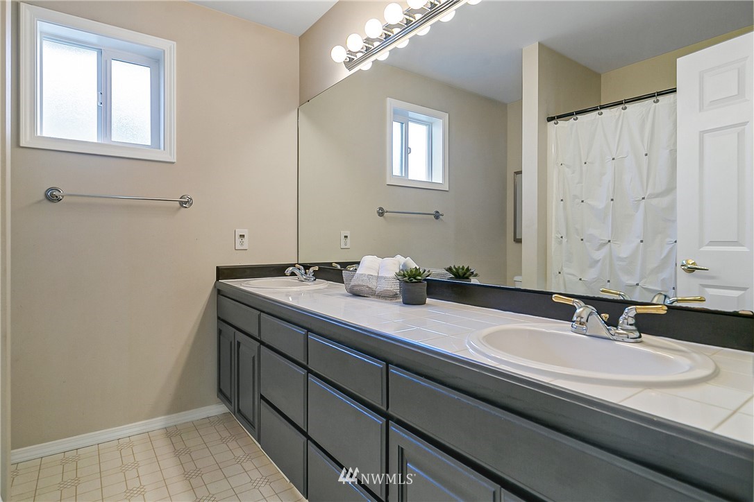 1127 185th Place Southeast Bothell, WA 98012 - Photo 22 of 25 a bathroom with a sink and a mirror