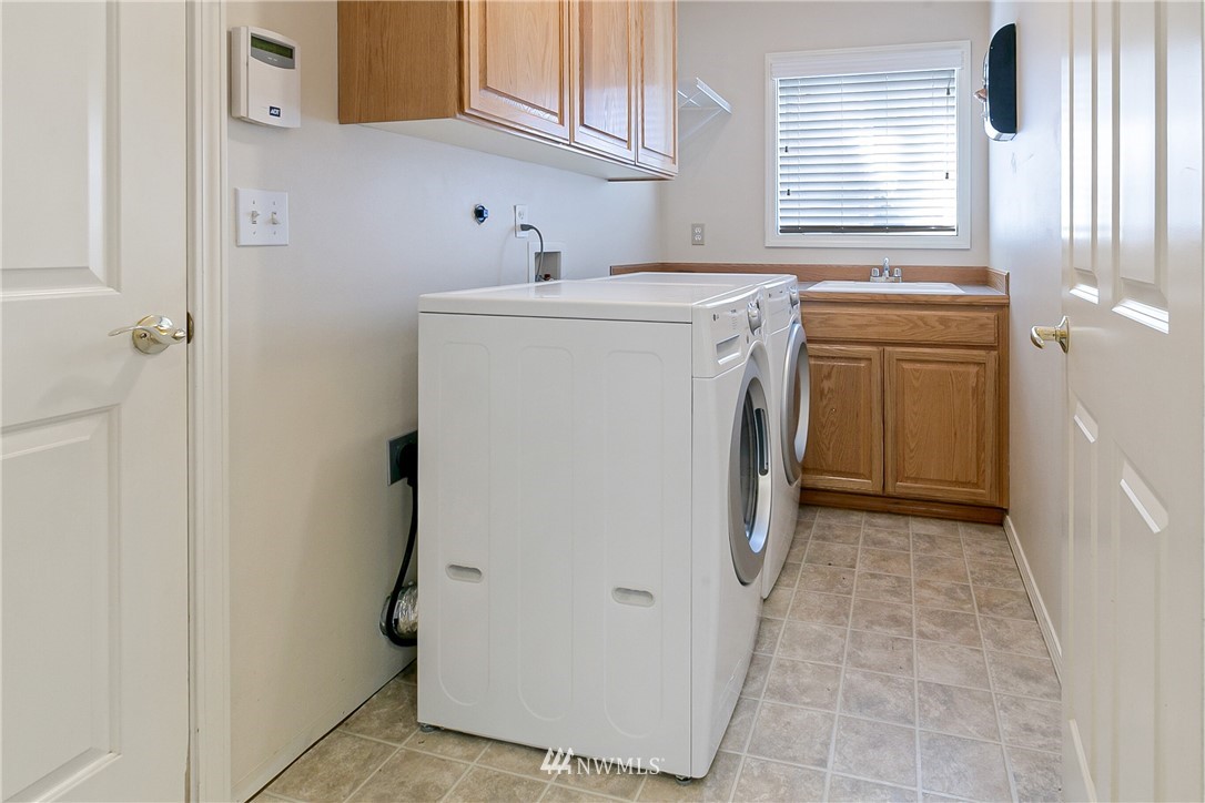 1127 185th Place Southeast Bothell, WA 98012 - Photo 23 of 25 a utility room with cabinets washer and dryer