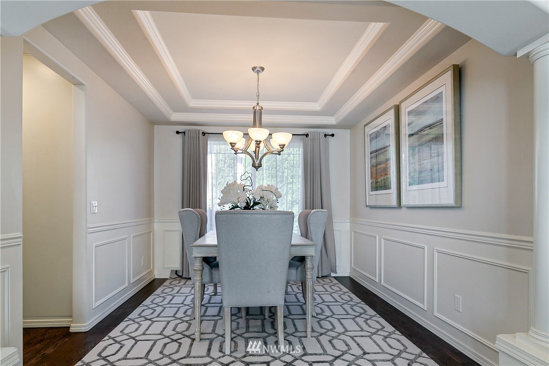 1127 185th Place Southeast Bothell, WA 98012 - Photo 5 of 25 a dining room with furniture a chandelier and wooden floor