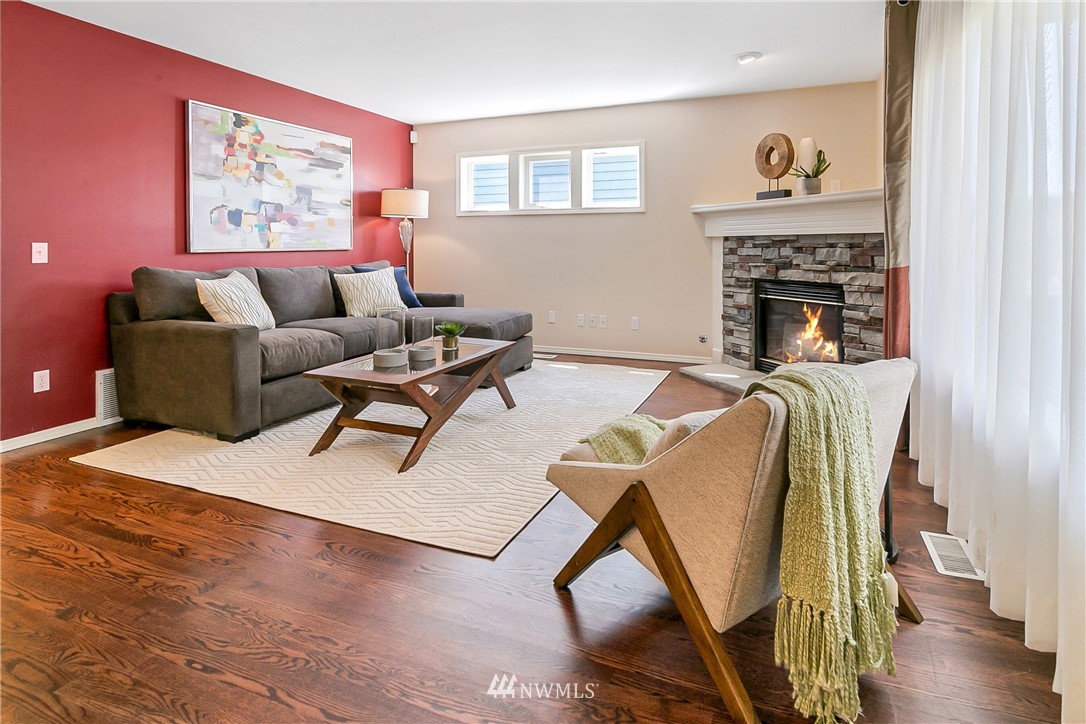 1127 185th Place Southeast Bothell, WA 98012 - Photo 10 of 25 a living room with furniture and a fireplace