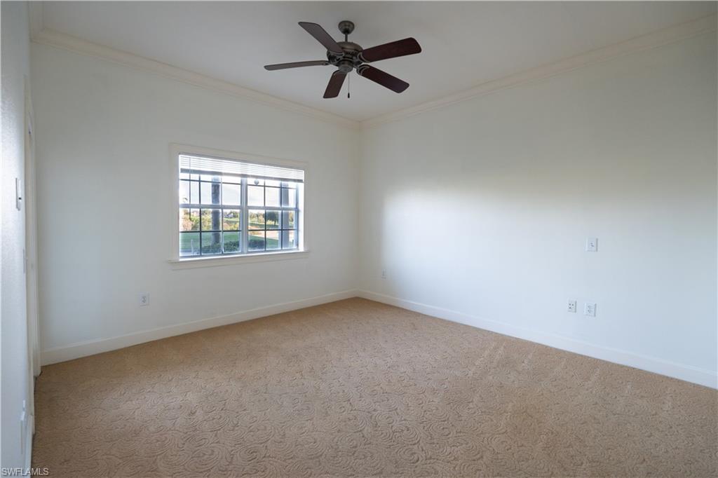 1362 Centre Ct Ridge Drive, Unit 101 Reunion, FL 34747 - Photo 14 of 25 Empty room with ceiling fan, carpet floors, and crown molding