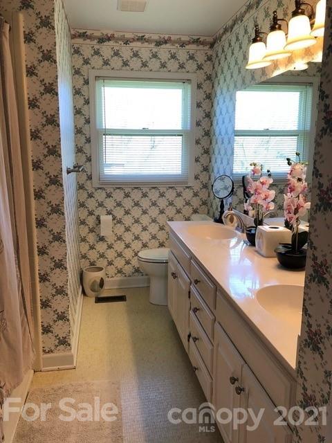130 Lyn Road Salisbury, NC 28147 - Photo 11 of 15 a bathroom with a double vanity sink mirror and shower