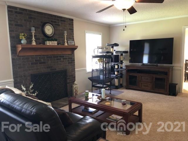 130 Lyn Road Salisbury, NC 28147 - Photo 5 of 15 a living room with furniture a flat screen tv and a fireplace