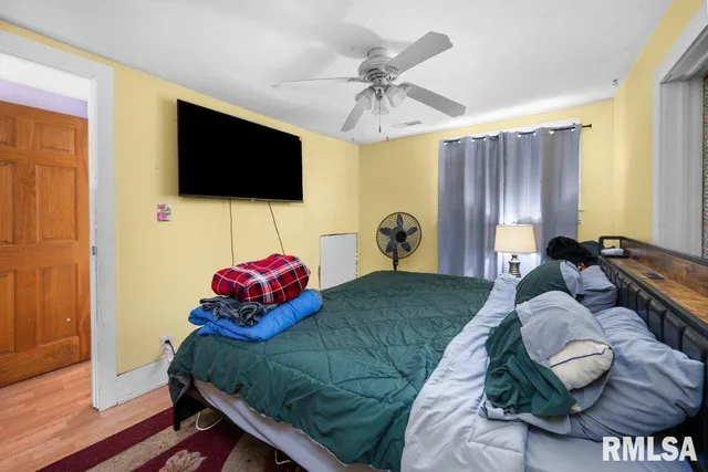 a bedroom with a bed and flat screen tv