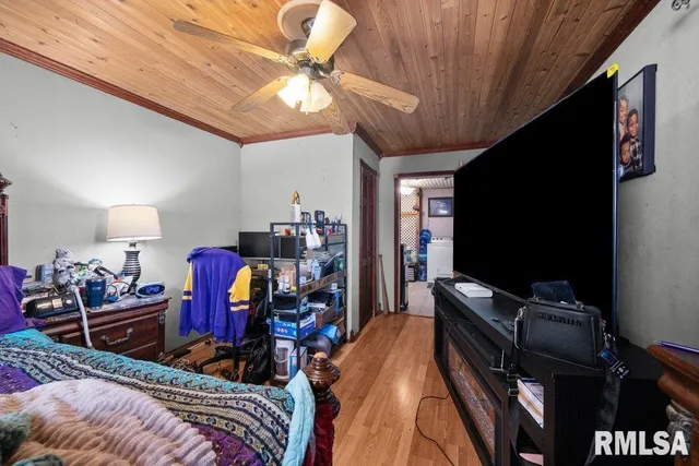 a bedroom with furniture and a flat screen tv