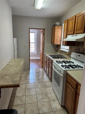 a kitchen with a stove a sink and a refrigerator