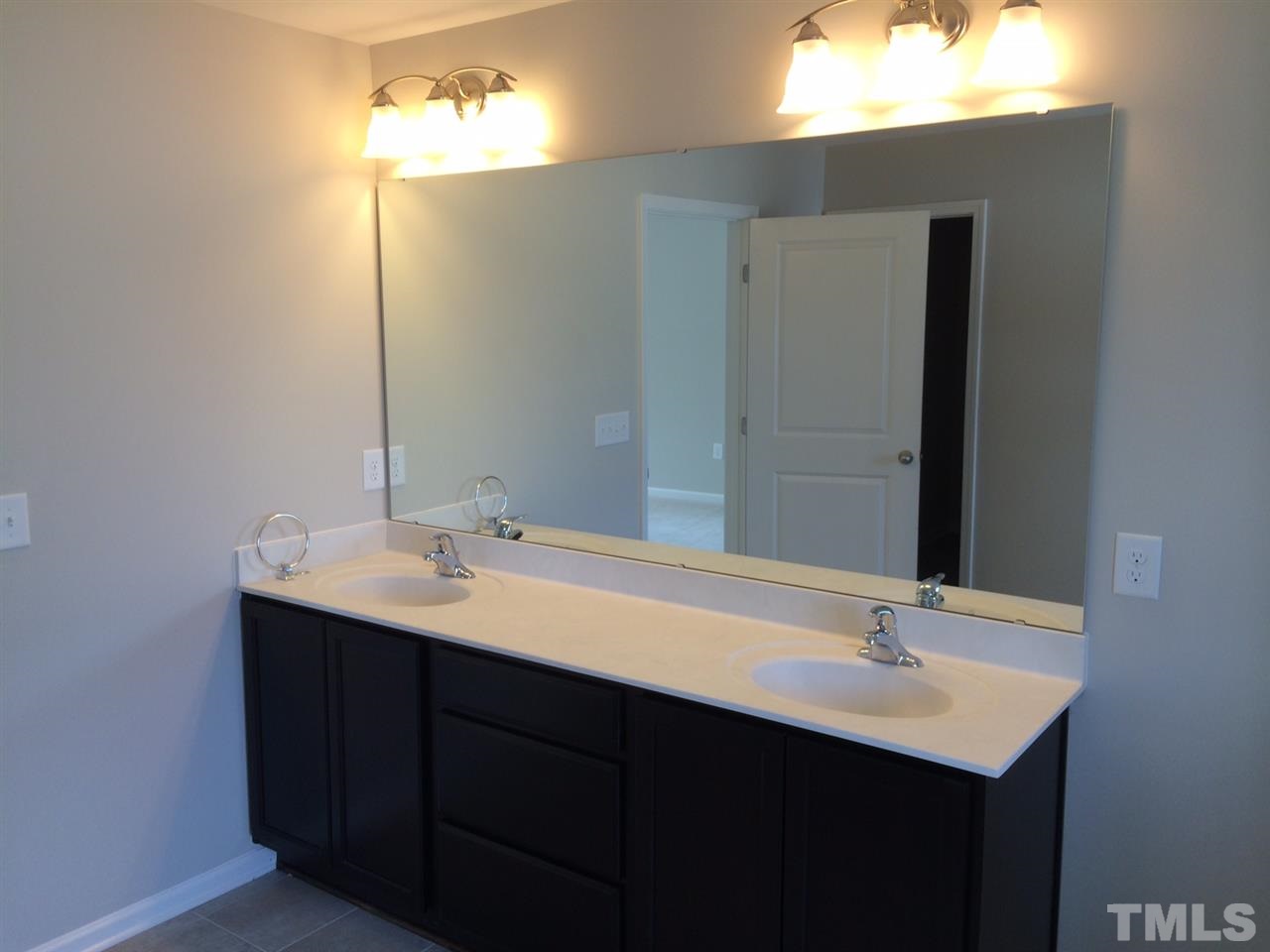 7621 Channery Way Raleigh, NC 27616 - Photo 12 of 25 the brushed nickel lighting fixtures offer ample lighting