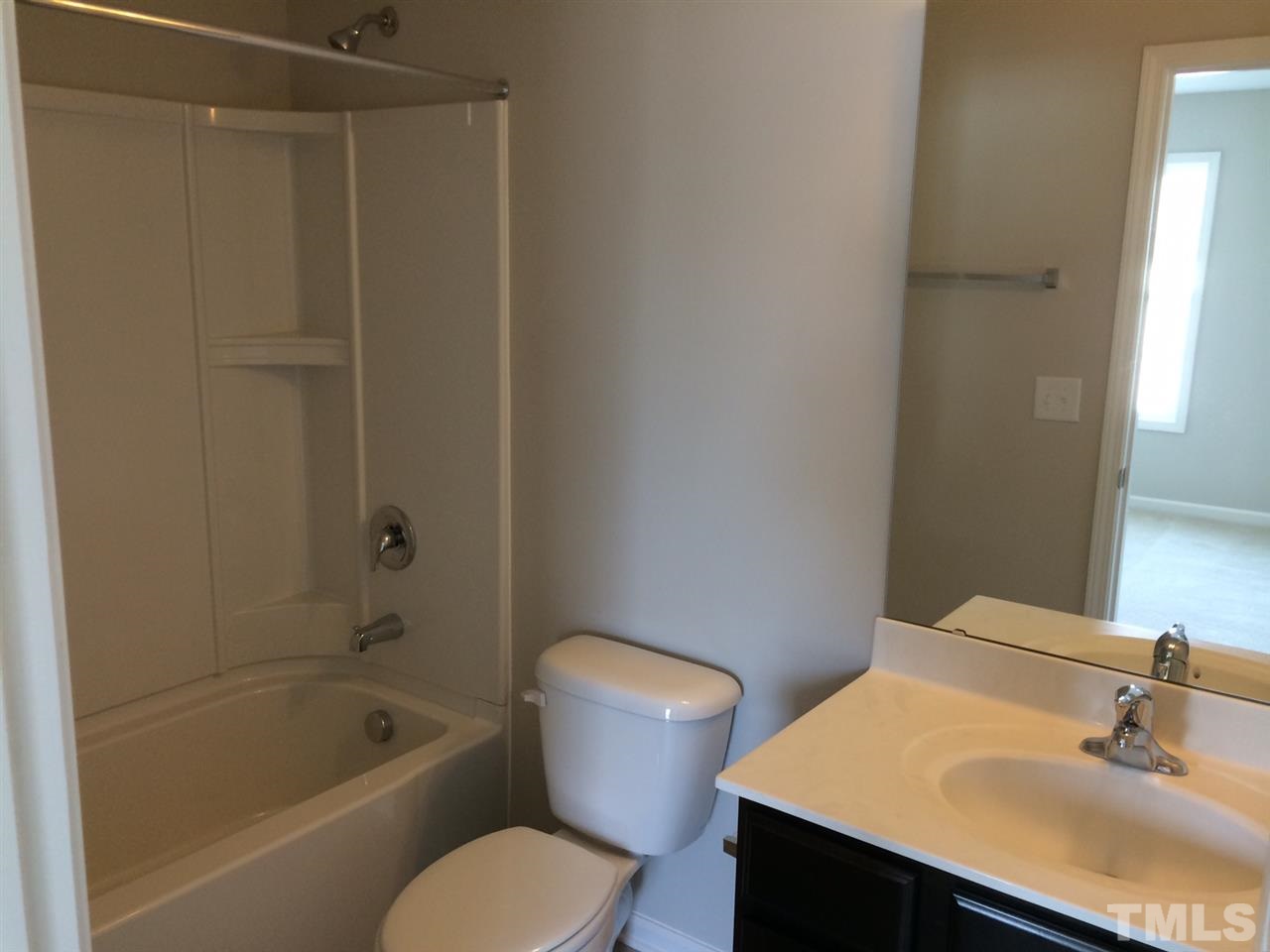 7621 Channery Way Raleigh, NC 27616 - Photo 14 of 25 cultured marble counter tops and shower/tub surround offers shelving for lotions, gels & loufas