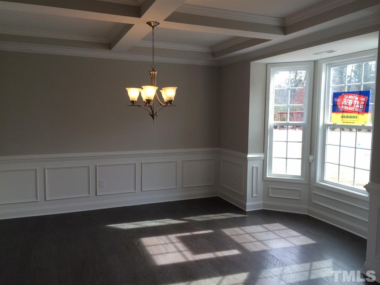 7621 Channery Way Raleigh, NC 27616 - Photo 7 of 25 coffered ceiling with crown molding, small nook window, hardwoods along with chair wail and wainscoting. check out the natural light