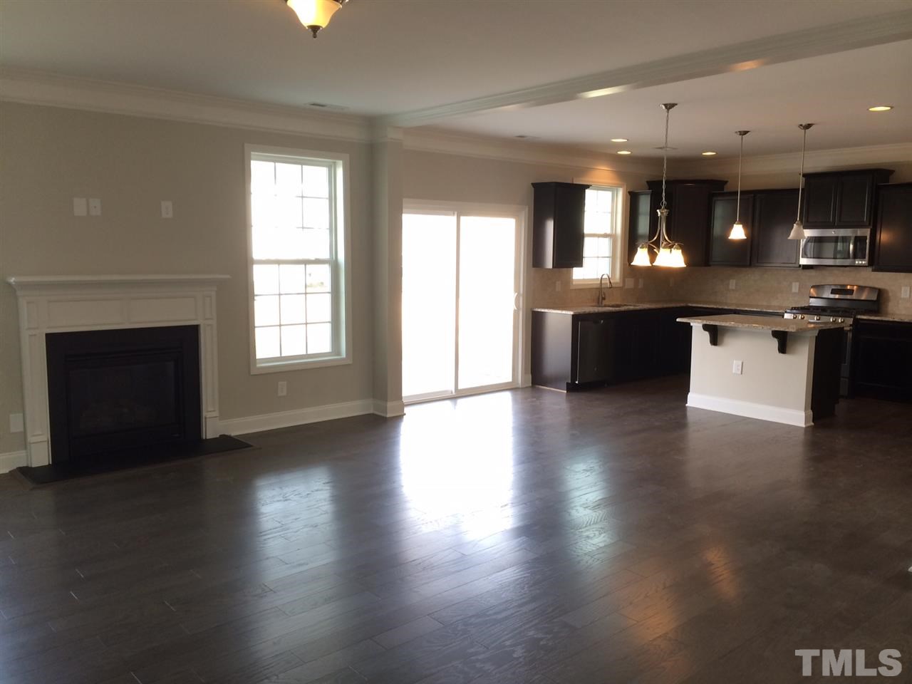 7621 Channery Way Raleigh, NC 27616 - Photo 8 of 25 gotta love the hardwoods, the 2 piece crown molding and the gas fireplace.