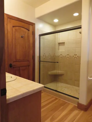 a view of a tree with snow on the road