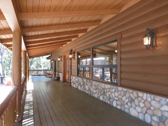 a large kitchen with stainless steel appliances kitchen island a large counter top and wooden floors
