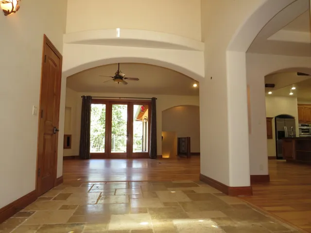a kitchen with stainless steel appliances granite countertop a refrigerator and a stove top oven